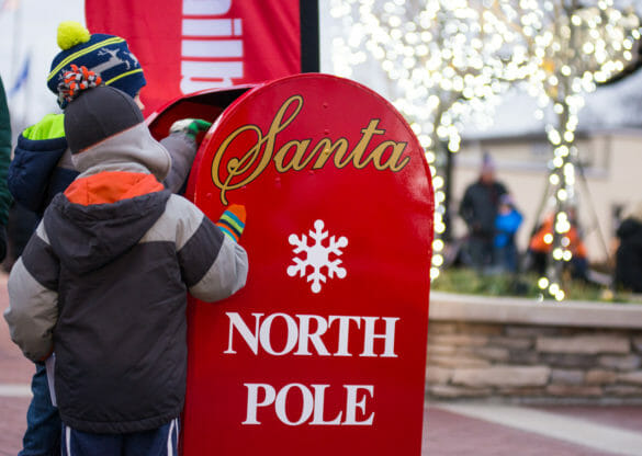 child delivering letter to santa