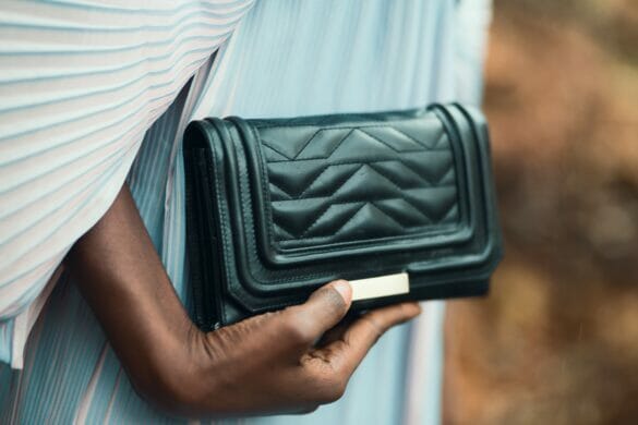 Woman holding black clutch