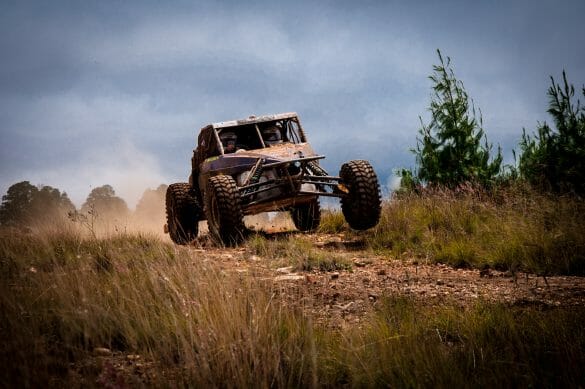 Off road vehicle going down a dirt road