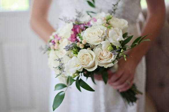 close up of woman holding bridal bouquet