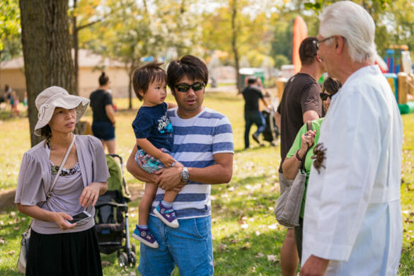 People looking at man with spider on him