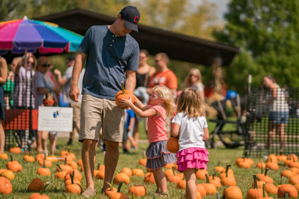 girls choosing pumpkins