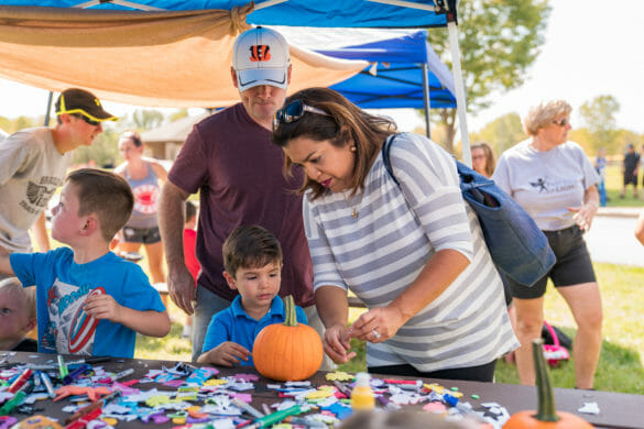 boy decorating pumpkin