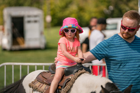 girl on horse with dad