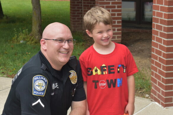Boy and officer posing