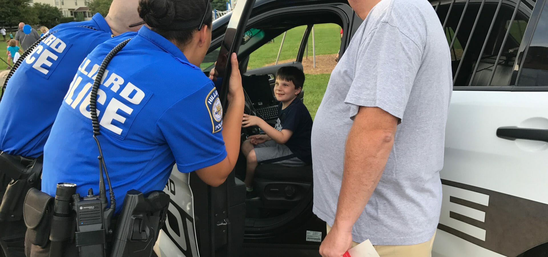 Boy inside police car