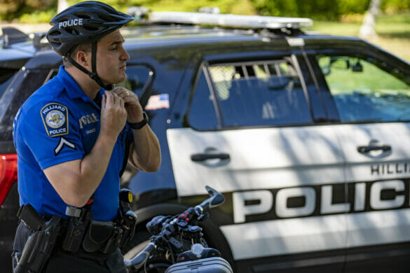 Officer putting on a helmet