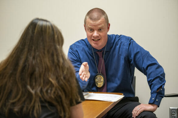 A detective speaking with a witness