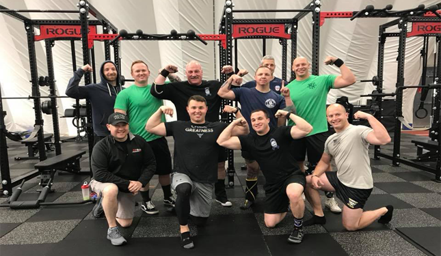 officers posing and flexing at a gym