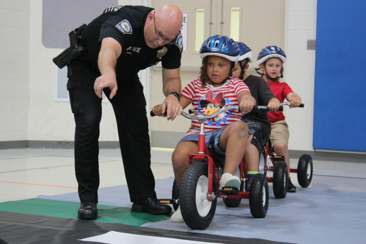 Officer instructing kids at Safety Town