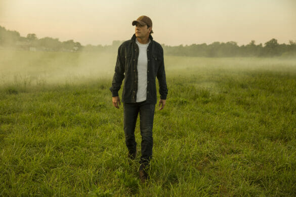 Country singer Rodney Atkins walking through a field