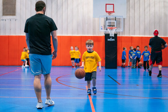 A little boy dribbling