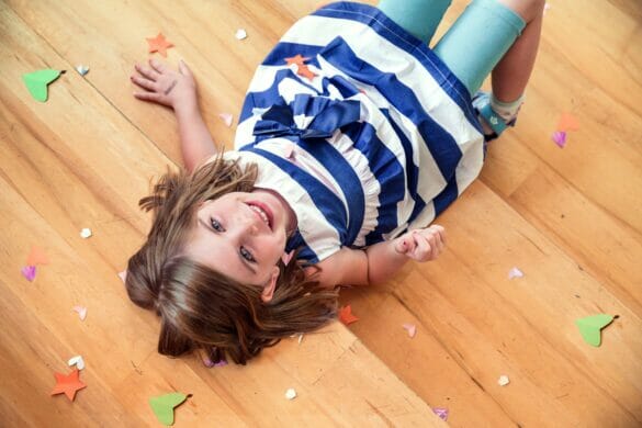 A little girl surrounded by confetti