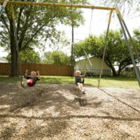 A boy and girl swinging