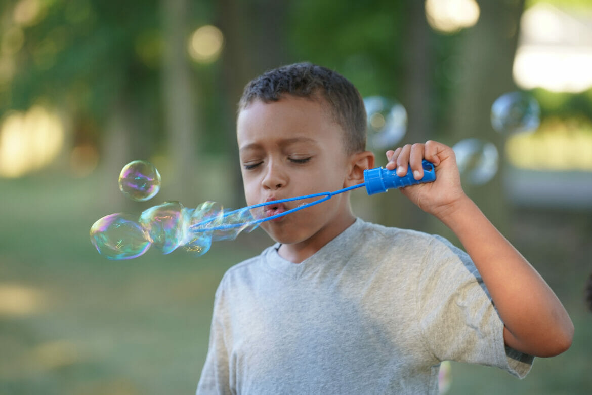A boy blowing bubbles