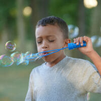 A boy blowing bubbles