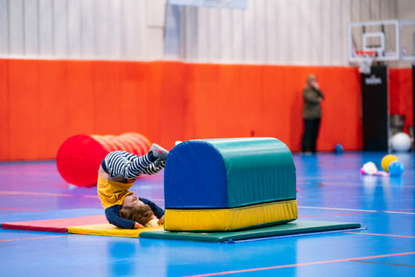Boy tumbling in gym