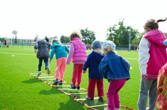 kids outside playing on an obstacle coarse