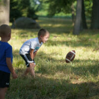 Two boys playing with a football