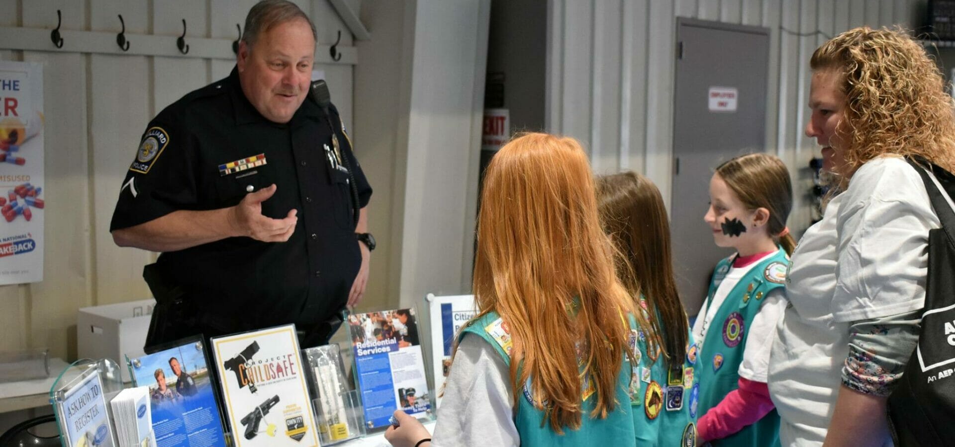 Officer Deaton talking to a group of girl scouts