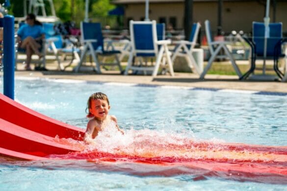 Boy sliding down water slide