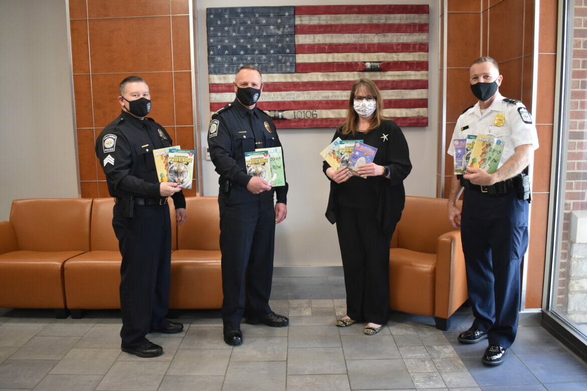 Officers holding up books