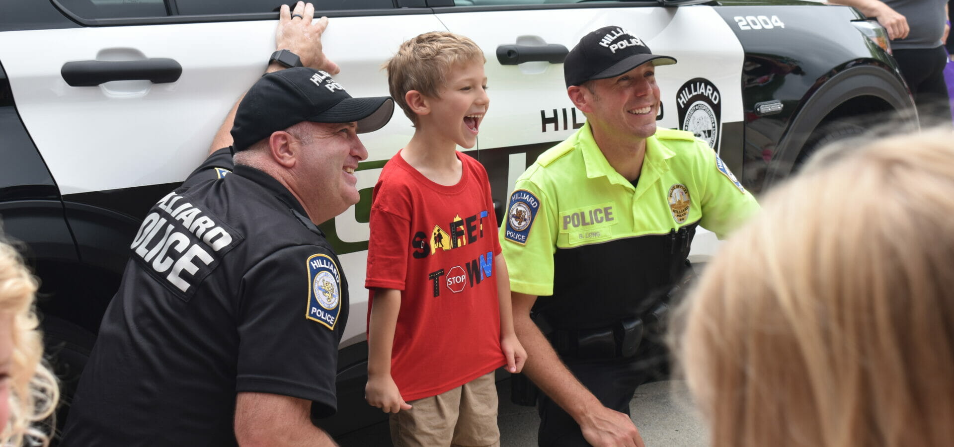 Officers posing with kid