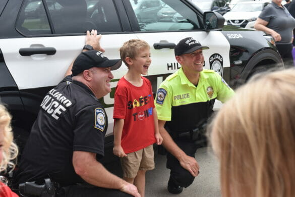 Officers posing with kid