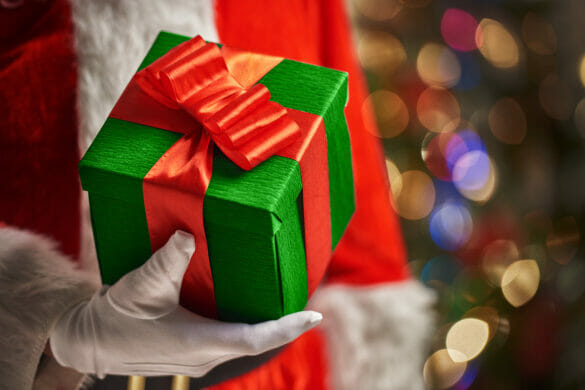 Hands of Santa Claus with Christmas present