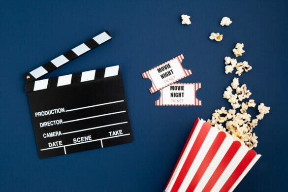 Movie clapperboard and cinema tickets. Home movie night, party invitation. Top view, copy space, mockup