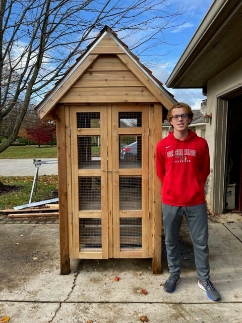 Eagle Scout standing in front of project for Rec and Parks