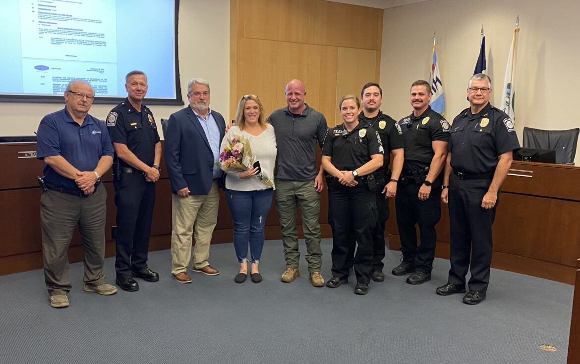 Jennifer Powell and James Ashenhurst, center, are joined by members of the Hilliard Division of Police. Powell received HPD's Good Citizen Award for her evasive driving that officers believe saved Ashenhurst's life.