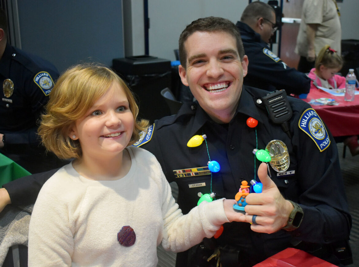 Police officer and child play with clay snowman