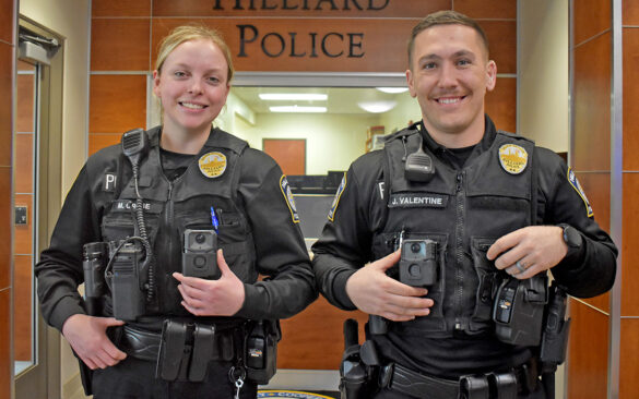 Male and Female Police Officers wearing body cameras