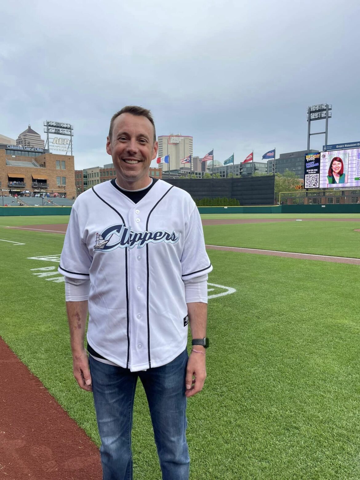 Photo of Detective Long standing on the ballfield with a Clippers jersey