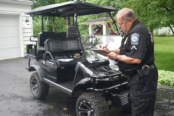 Police officer performs golf cart inspection