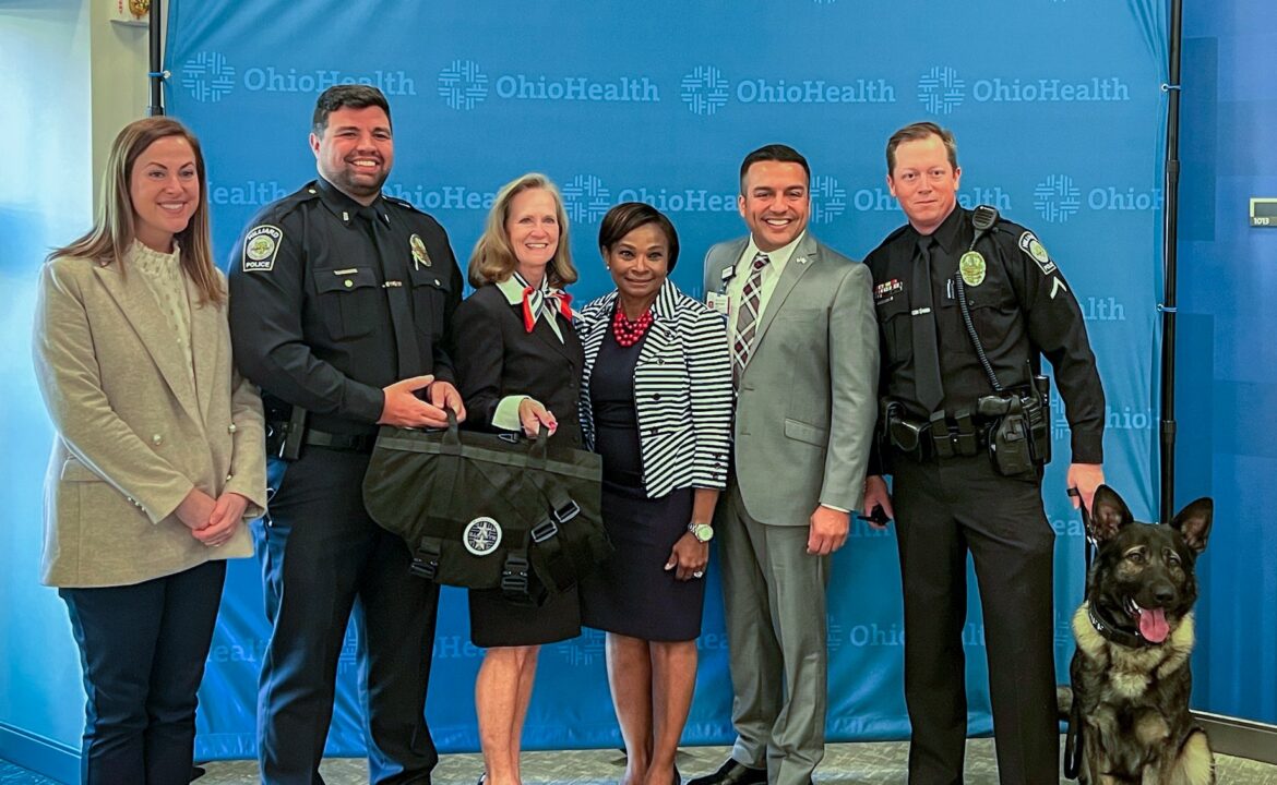 OhioHealth veterans present K9 Griff with a protective vest.