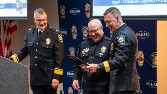 Detective Mike Metz, retiring with 38 years of service with the City of Hilliard Division of Police, reads a plaque at his retirement ceremony.