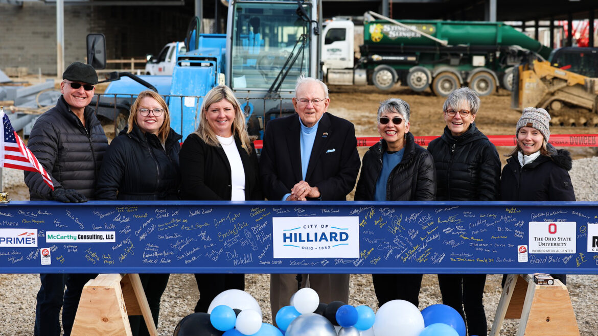 Roger Reynolds poses with members of Hilliard City Council at the Beam Topping event for The Well, Hilliard's new recreation and wellness facility in February 2024. 