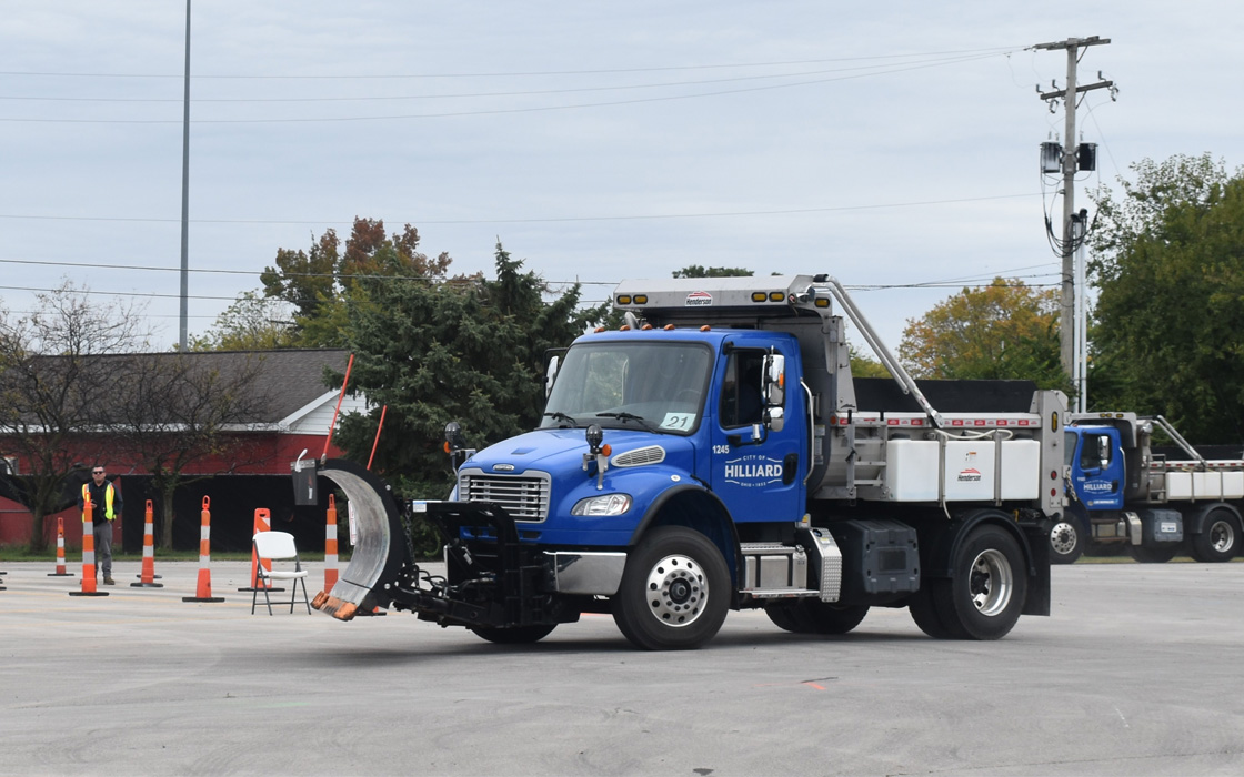 Photo of a snow plow truck in a parking lot