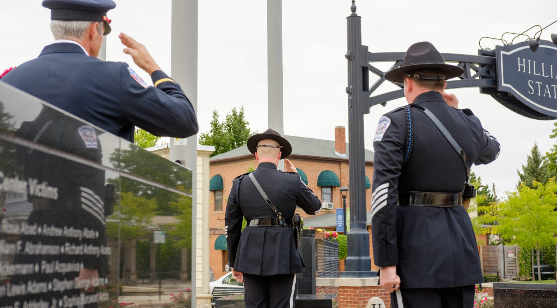 Officers saluting at memorial event