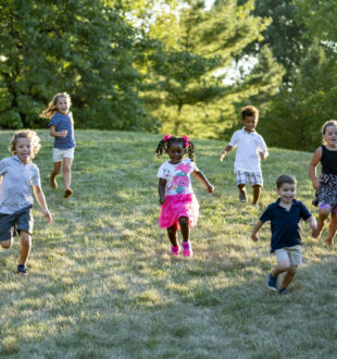 A group of kids running down a hill
