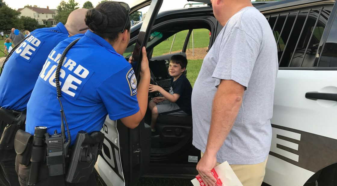 Boy inside police car