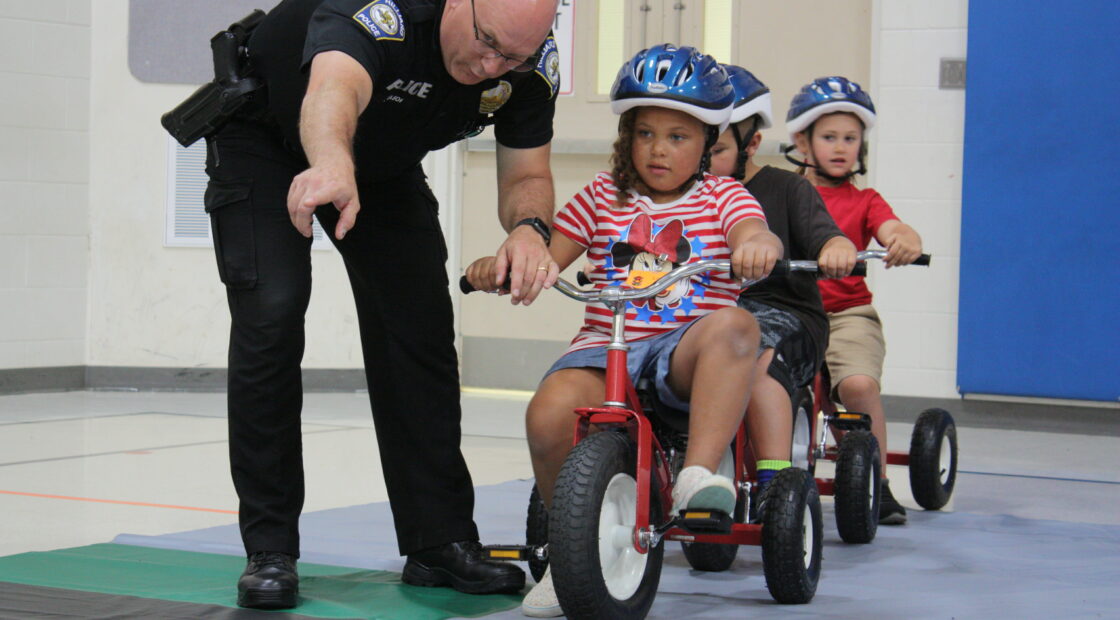 Officer instructing kids at Safety Town